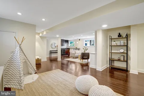 a living room with furniture a wooden floor and a large window