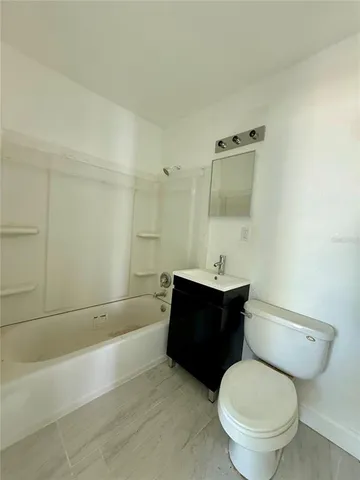 a bathroom with a toilet a sink and bathtub