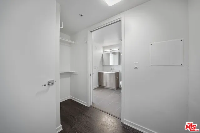 a view of a room with wooden floor and a sink