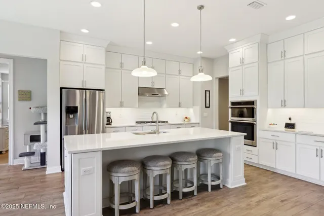 a bedroom with a bed a couch and a large window