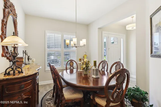 a bedroom with a bed a dresser next to a window