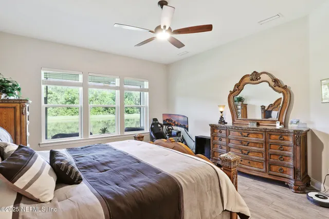 a bedroom with a bed and a chair