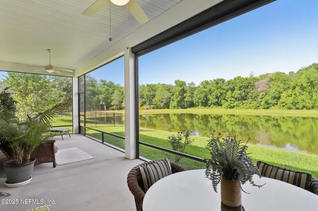 a view of a porch with furniture and floor to ceiling window