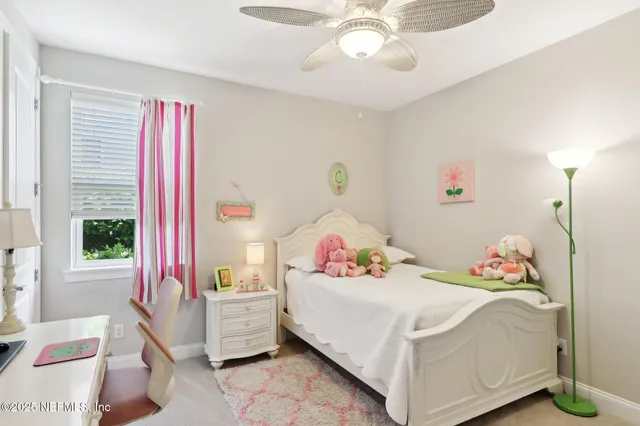 an aerial view of residential houses with outdoor space and parking