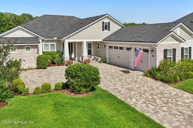 a view of a room with lots of wooden furniture and windows