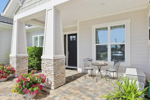 a large kitchen with kitchen island white cabinets and stainless steel appliances
