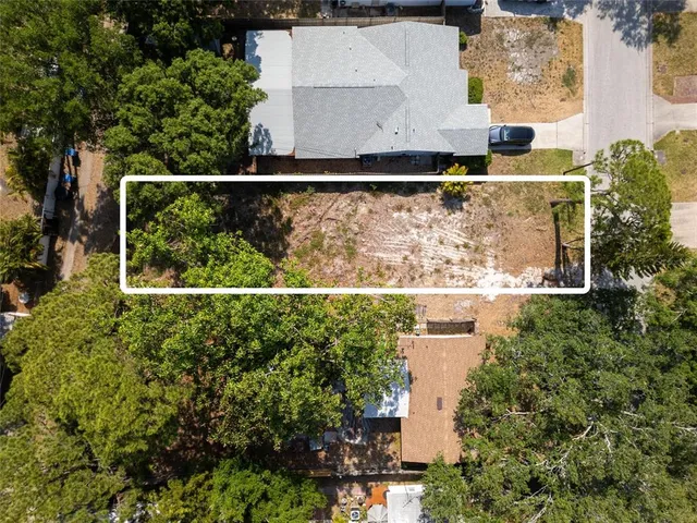 an aerial view of residential houses with outdoor space and swimming pool