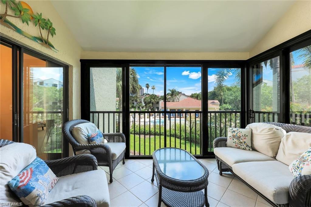 a living room with furniture and a floor to ceiling window