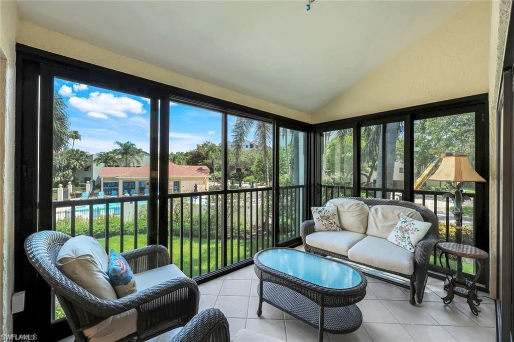 6555 Valen Way, Unit G201 Naples, FL 34108 - Photo 4 of 28 a living room with furniture and a large window