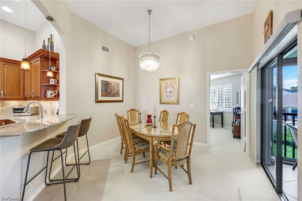6555 Valen Way, Unit G201 Naples, FL 34108 - Photo 7 of 28 a dining room with furniture and window