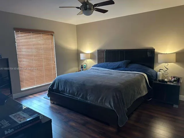 a bedroom with a bed and a mirror