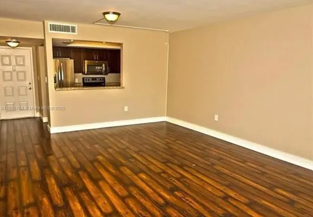 a view of a room with wooden floor