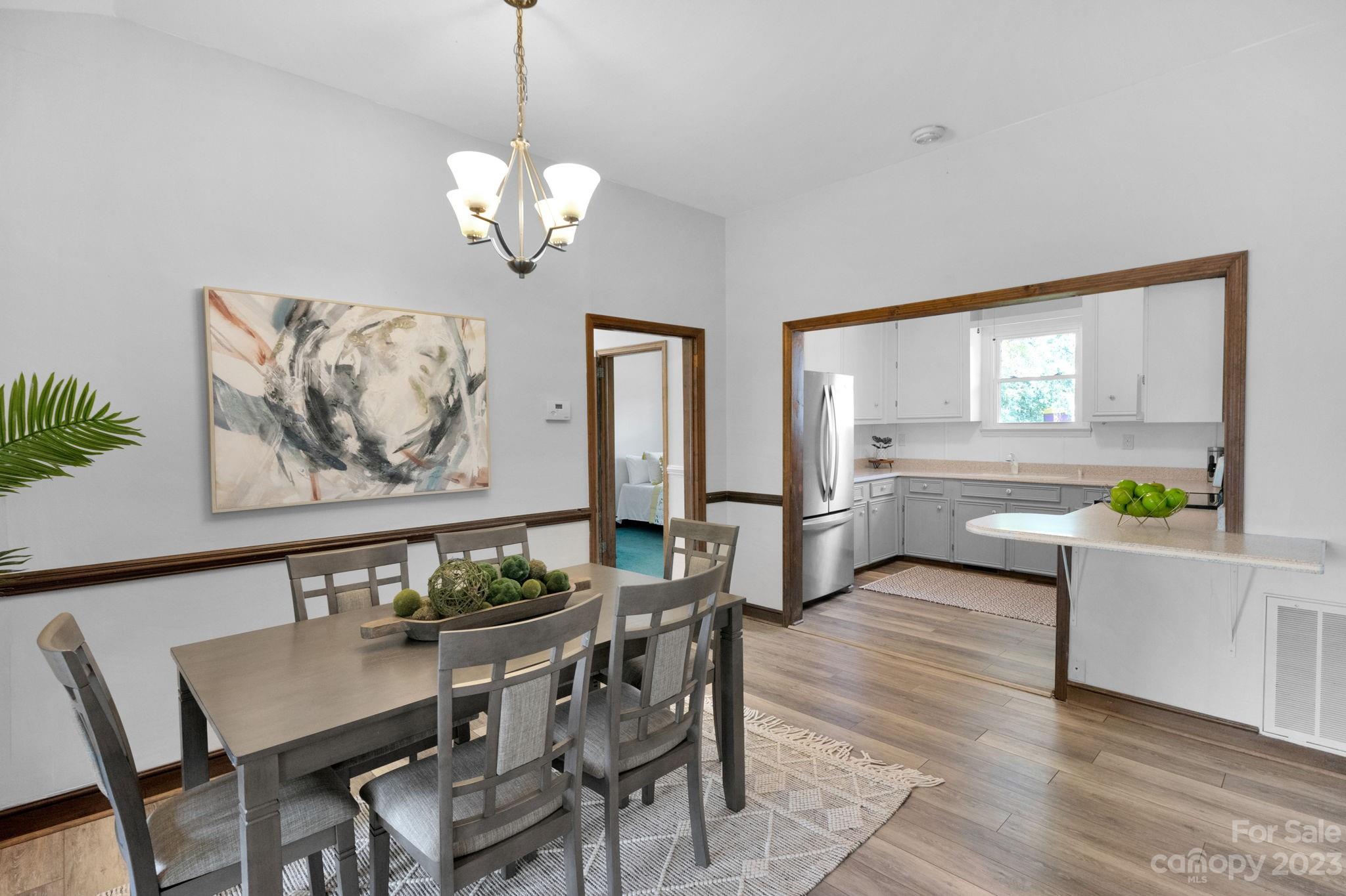 2075 Rolling Hills Road Ridgeway, SC 29130 - Photo 8 of 40 a view of a dining room with furniture a chandelier and wooden floor
