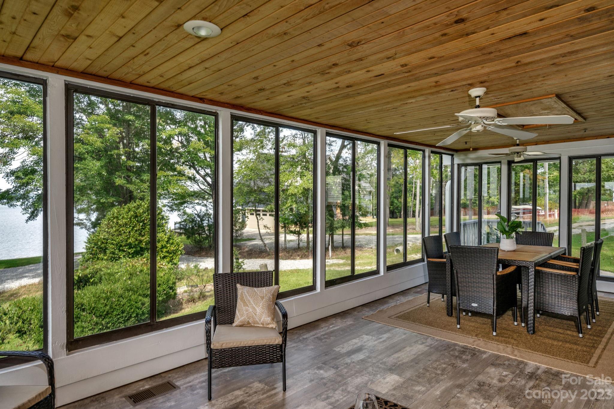 2075 Rolling Hills Road Ridgeway, SC 29130 - Photo 10 of 40 a view of a dining room with furniture large windows and wooden floor