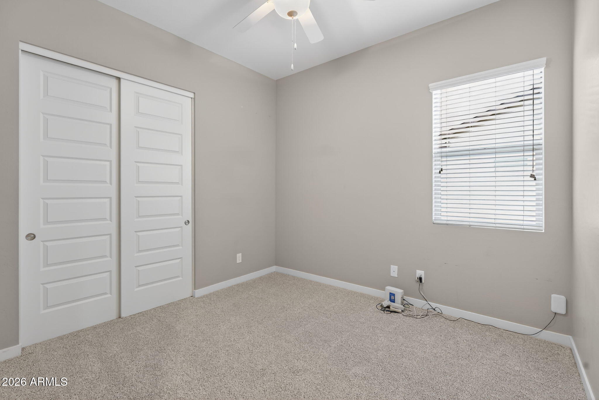 3075 East Appaloosa Road Gilbert, AZ 85296 - Photo 26 of 41 an empty room with a window and a fan