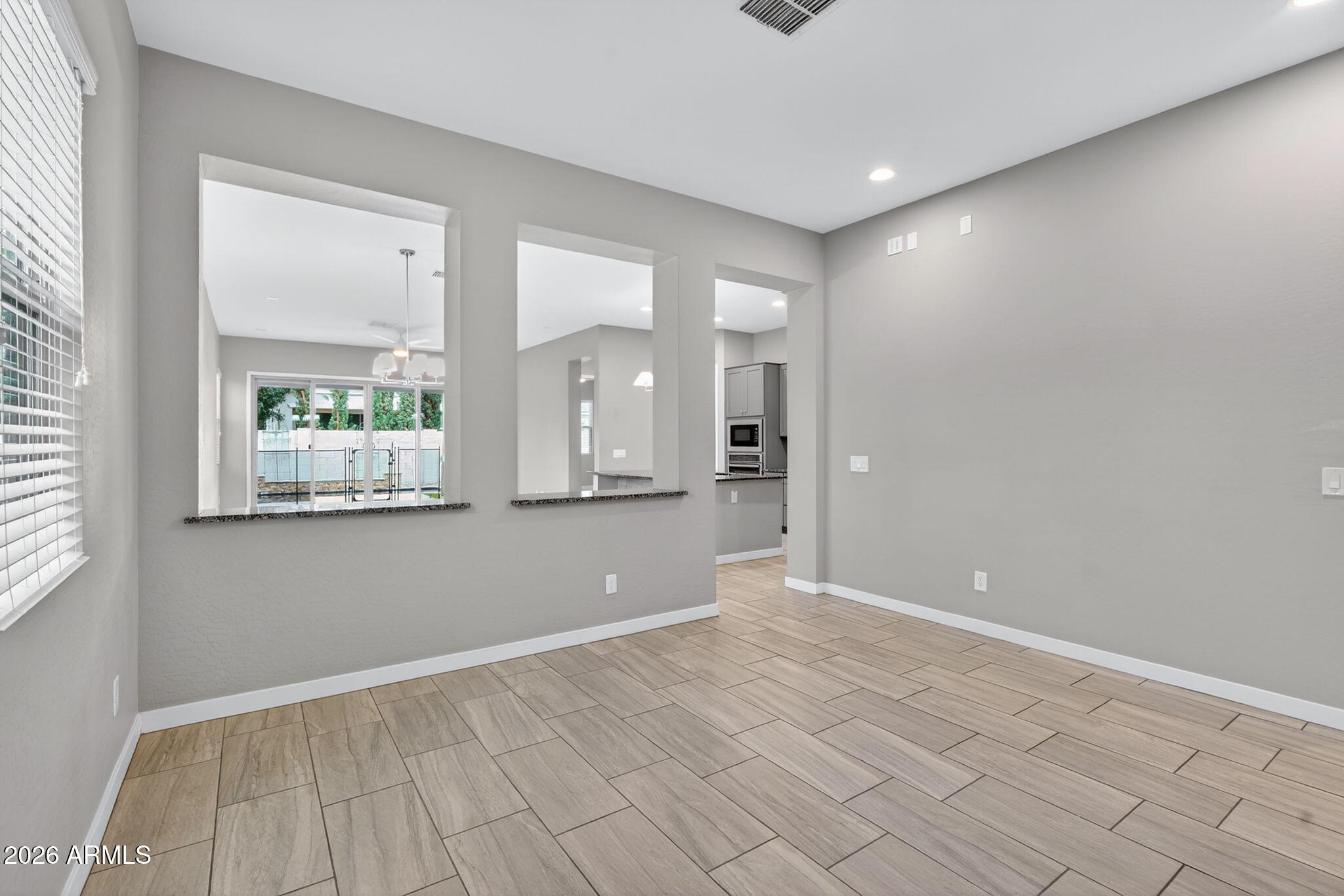 3075 East Appaloosa Road Gilbert, AZ 85296 - Photo 7 of 41 a view of an empty room with window and hardwood floor