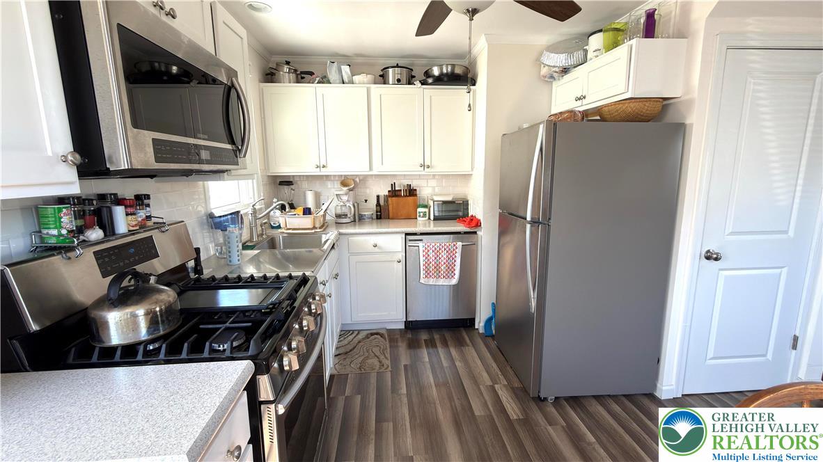 462 Maple Road Hellertown, PA 18055 - Photo 9 of 25 a kitchen with stainless steel appliances a refrigerator a sink a stove and cabinets