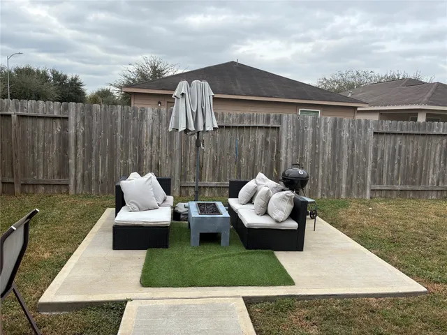a room with a mirror on dresser and a window