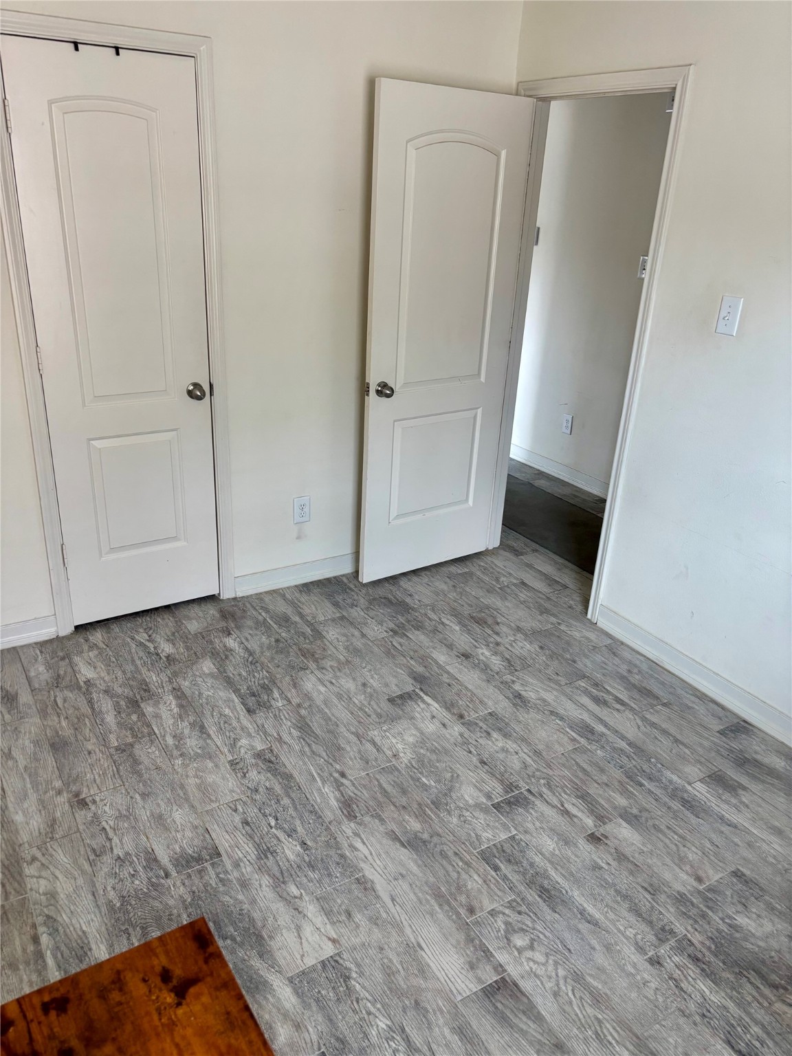 11230 Hall Ranch Court Houston, TX 77075 - Photo 6 of 21 an empty room with wooden floor and white doors