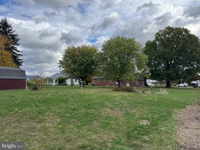 a kitchen with stainless steel appliances granite countertop a sink a stove a refrigerator with a dining table and chairs