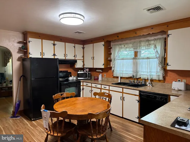 a kitchen with stainless steel appliances granite countertop a refrigerator sink and cabinets