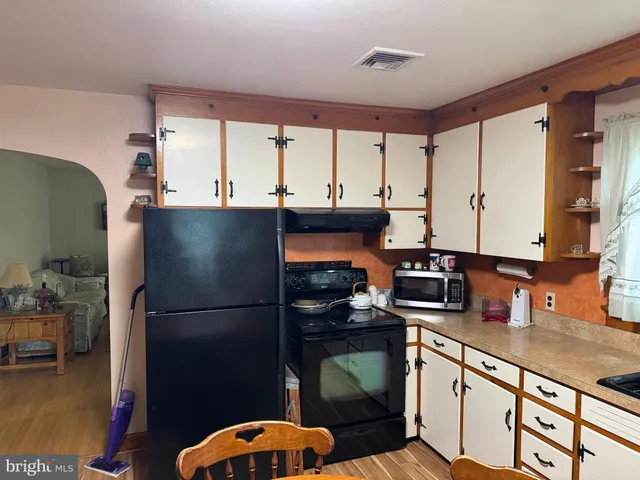 a kitchen with a table chairs and a refrigerator