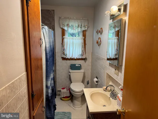 a bathroom with a sink and mirror with toilet