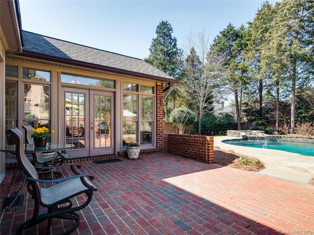 4822 Nora's Path Road Charlotte, NC 28226 - Photo 14 of 24 a view of a patio with dining table and chairs with wooden floor and fence