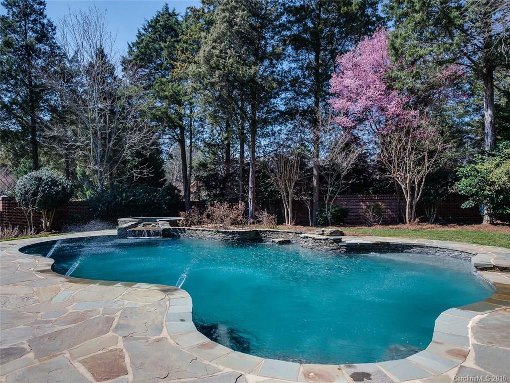 4822 Nora's Path Road Charlotte, NC 28226 - Photo 15 of 24 a view of a swimming pool with lawn chairs and a big yard