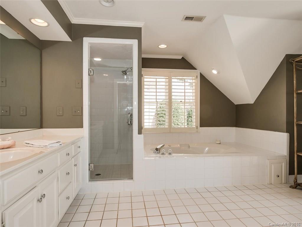 4822 Nora's Path Road Charlotte, NC 28226 - Photo 18 of 24 a bathroom with a bathtub a sink a vanity and a shower