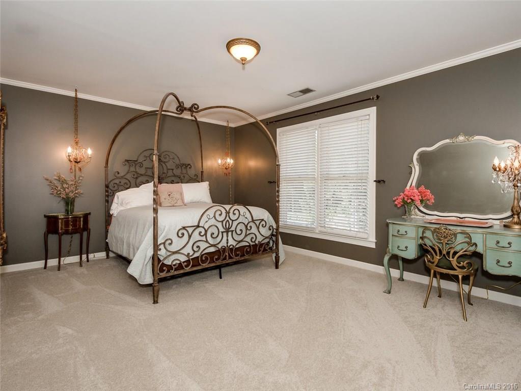4822 Nora's Path Road Charlotte, NC 28226 - Photo 20 of 24 a bedroom with a bed and a chandelier