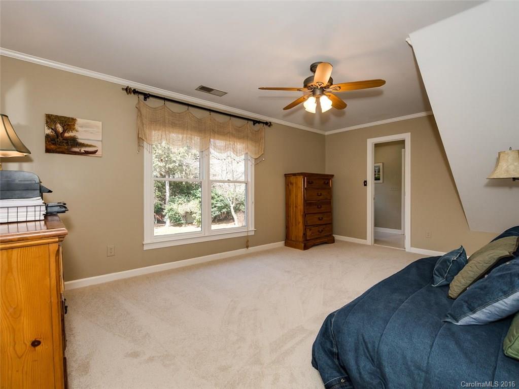 4822 Nora's Path Road Charlotte, NC 28226 - Photo 22 of 24 a bedroom with a bed and a chandelier