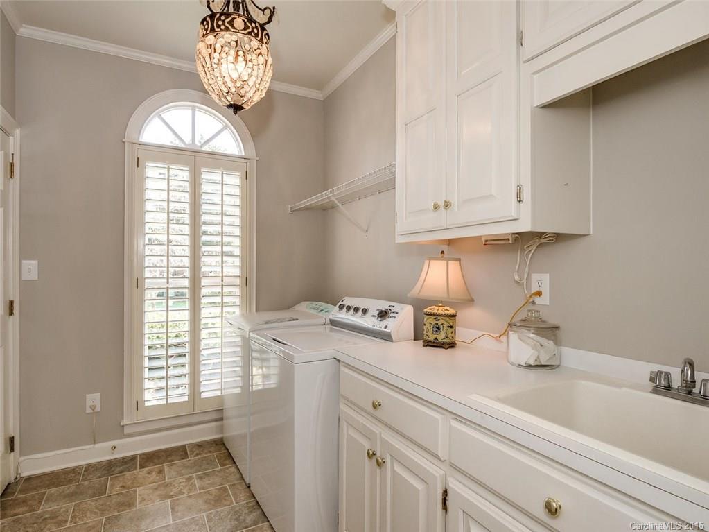 4822 Nora's Path Road Charlotte, NC 28226 - Photo 24 of 24 a kitchen with a window a sink and cabinets