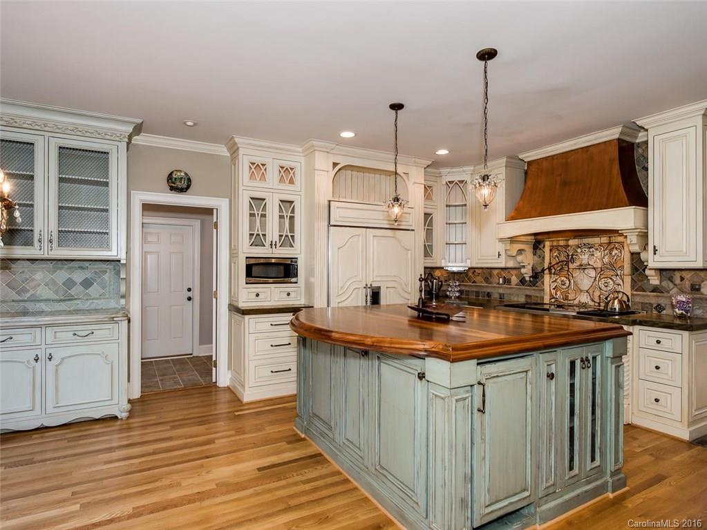 4822 Nora's Path Road Charlotte, NC 28226 - Photo 7 of 24 a kitchen with stainless steel appliances granite countertop a sink and a stove