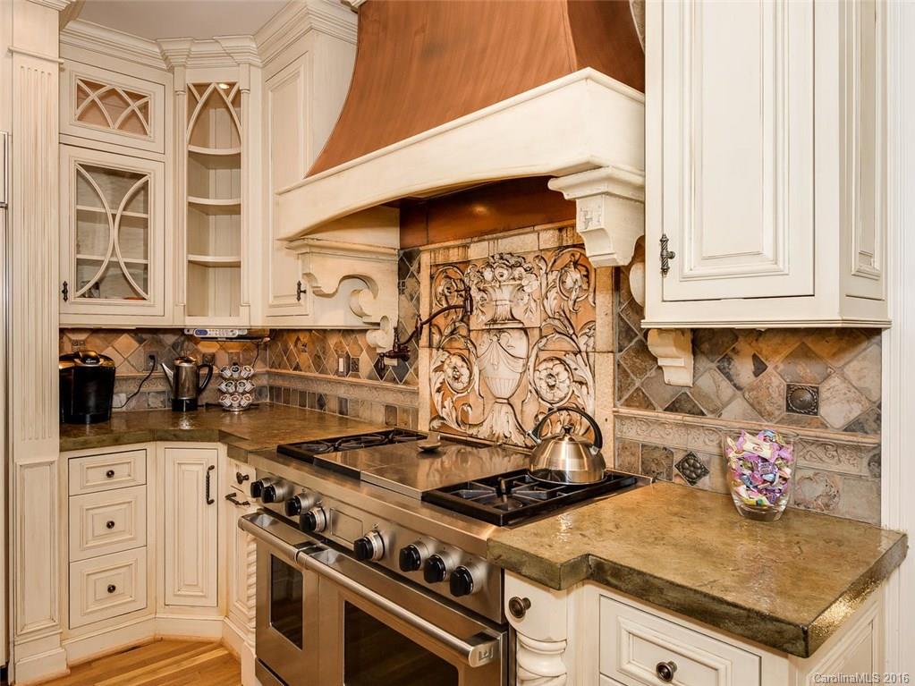 4822 Nora's Path Road Charlotte, NC 28226 - Photo 8 of 24 a kitchen with stainless steel appliances granite countertop a stove and a microwave