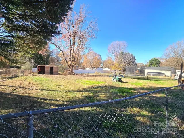 a view of a backyard with wooden fence