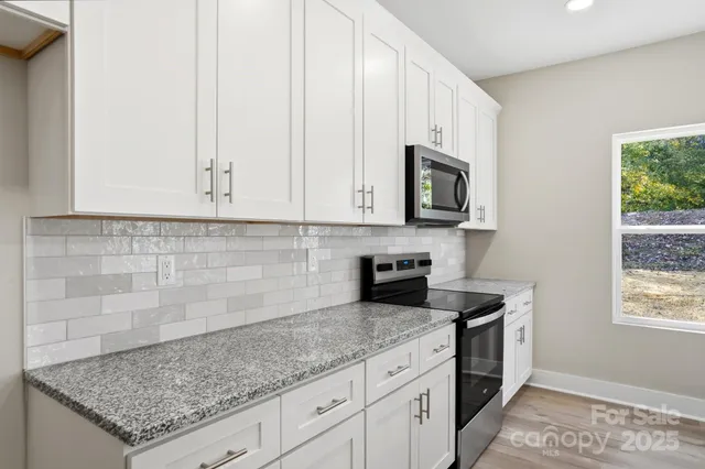 an aerial view of a house with a swimming pool yard and outdoor seating