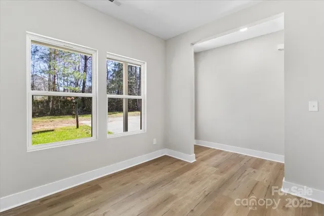 wooden floor in an empty room with a window and wooden floor