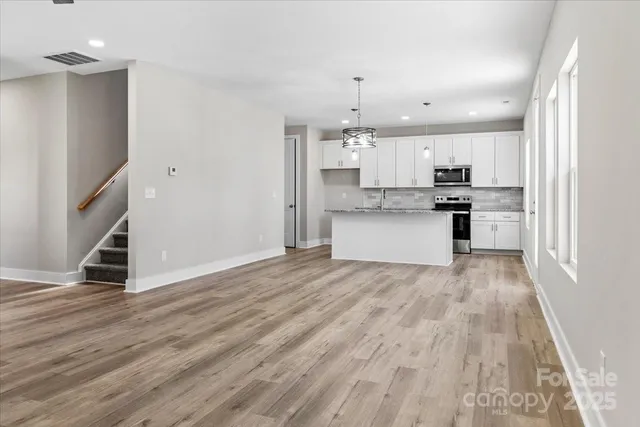 a bathroom with a granite countertop sink a toilet and a large mirror