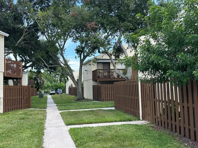 a front view of a house with yard and green space