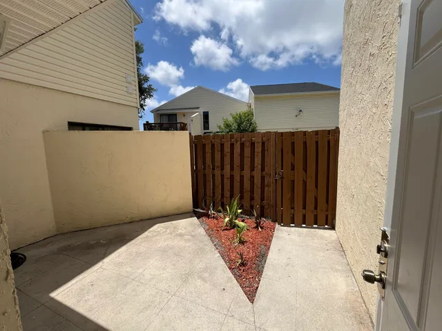 a view of a wooden door with a house