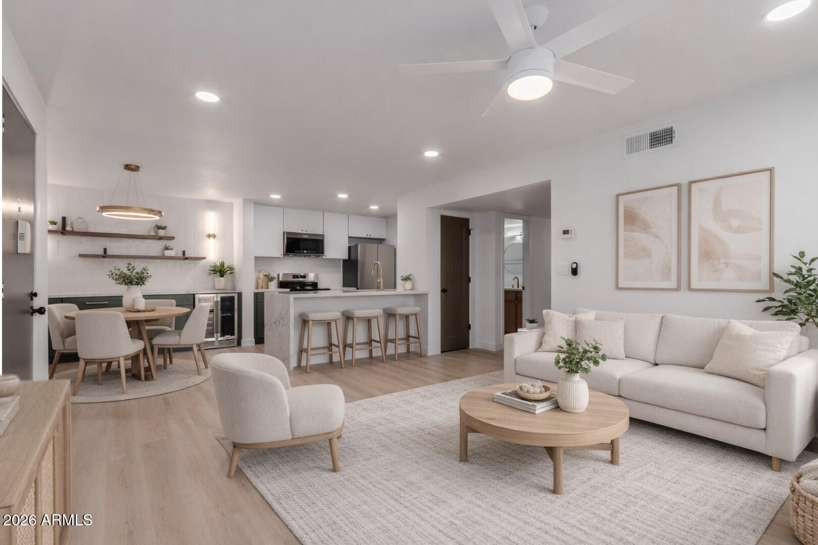 a living room with furniture and kitchen view