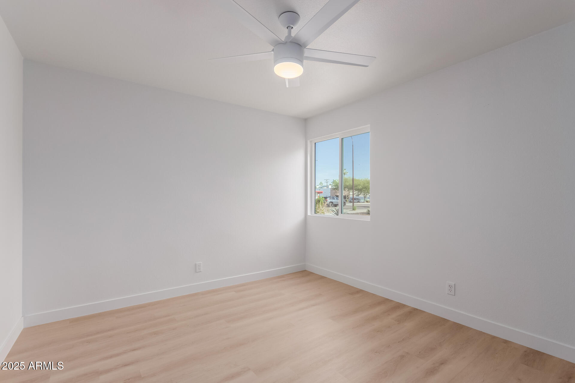 8055 East Thomas Road, Unit M101 Scottsdale, AZ 85251 - Photo 10 of 33 an empty room with a window and a ceiling fan