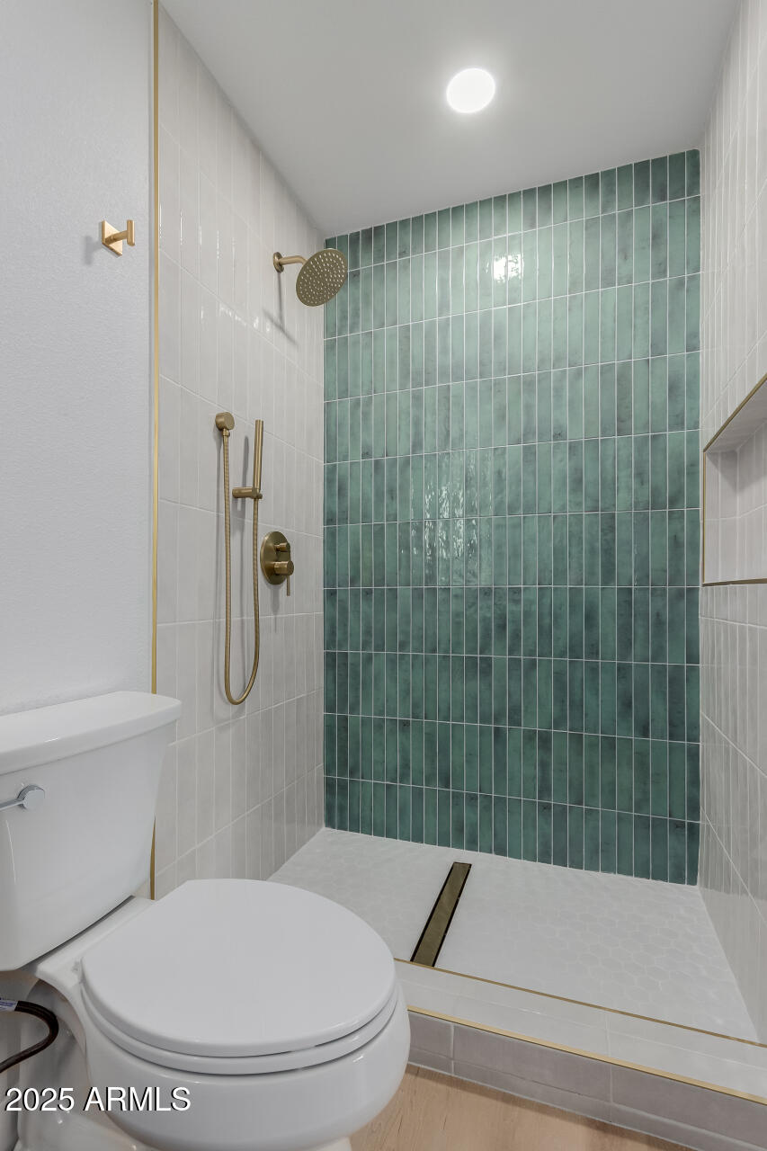 8055 East Thomas Road, Unit M101 Scottsdale, AZ 85251 - Photo 19 of 33 a bathroom with a toilet and a shower