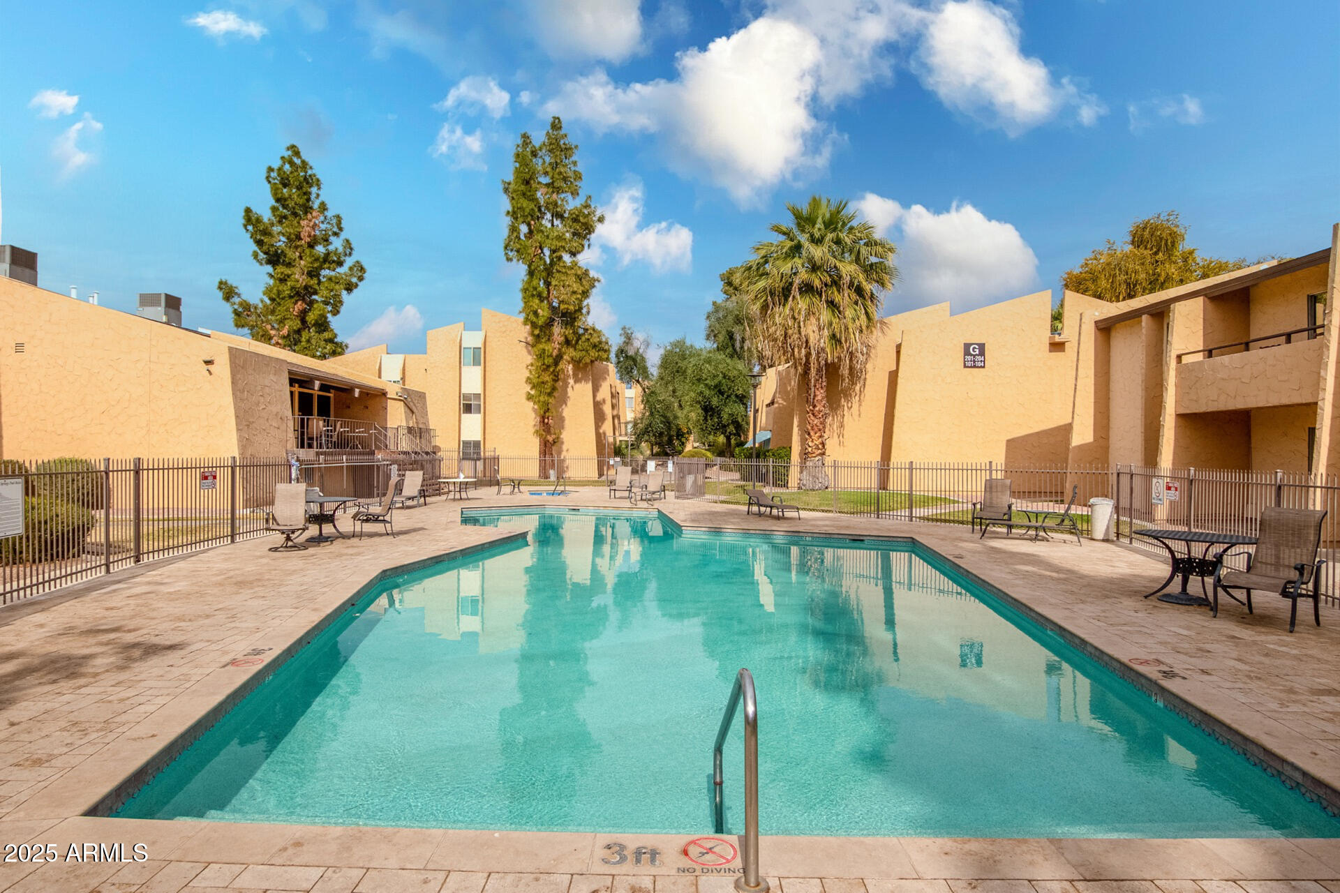 8055 East Thomas Road, Unit M101 Scottsdale, AZ 85251 - Photo 22 of 33 a swimming pool with outdoor seating and yard