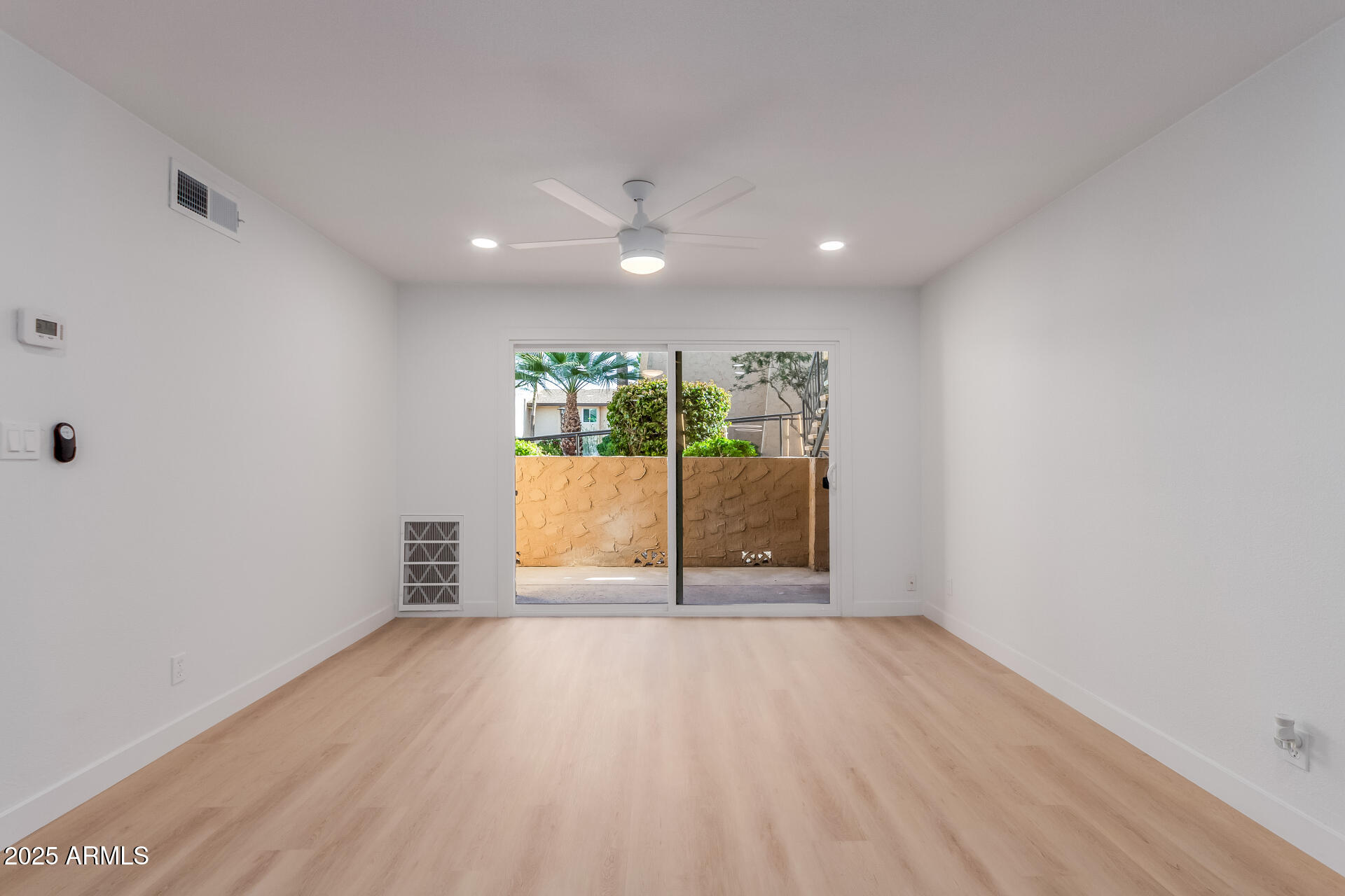 8055 East Thomas Road, Unit M101 Scottsdale, AZ 85251 - Photo 7 of 33 wooden floor in an empty room with a window
