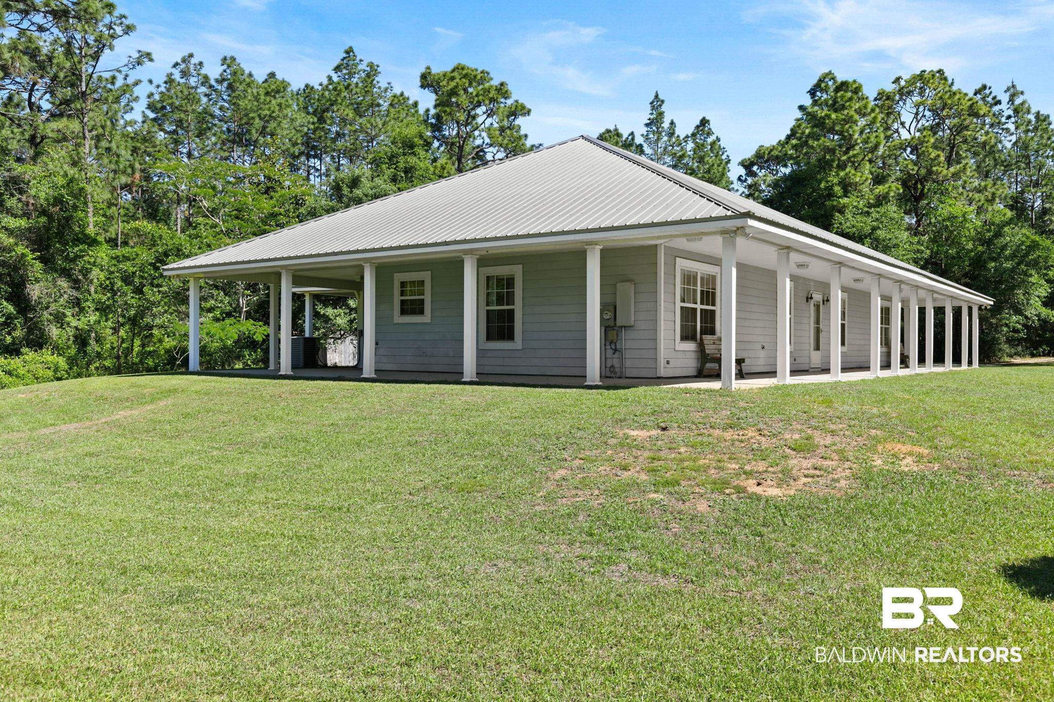 20219 Greek Cemetery Road Robertsdale, AL 36567 - Photo 7 of 41 Single-story residence featuring a light gray exterior siding and a light gray metal roof