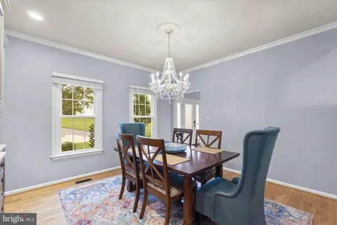 a living room with furniture a chandelier and a window