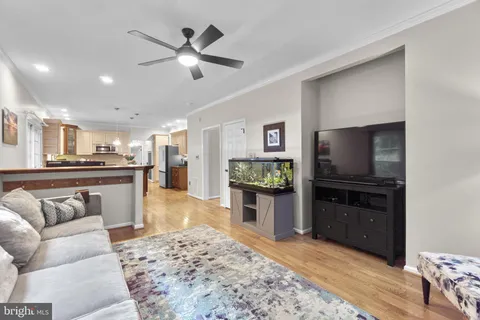 a kitchen with a stove a sink dishwasher a microwave oven with a dining table and chairs