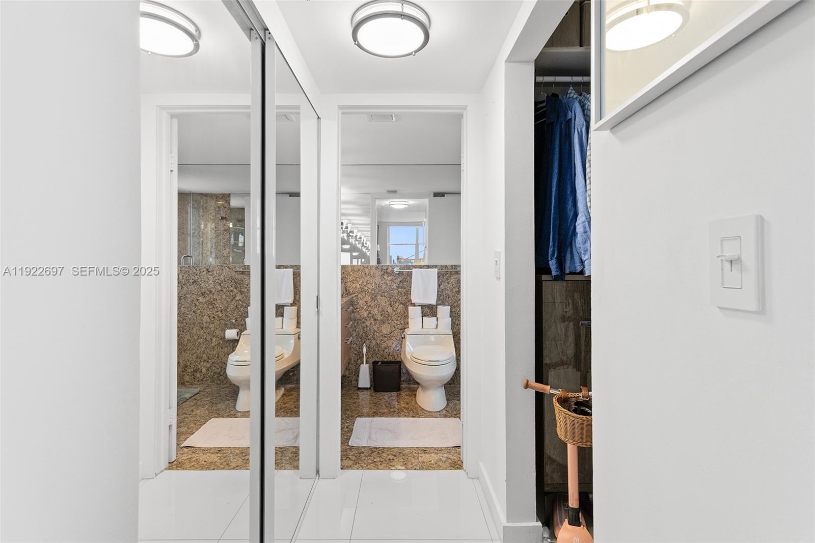 1775 Washington Avenue, Unit 14F Miami Beach, FL 33139 - Photo 16 of 25 a bathroom with a glass shower door and a mirror